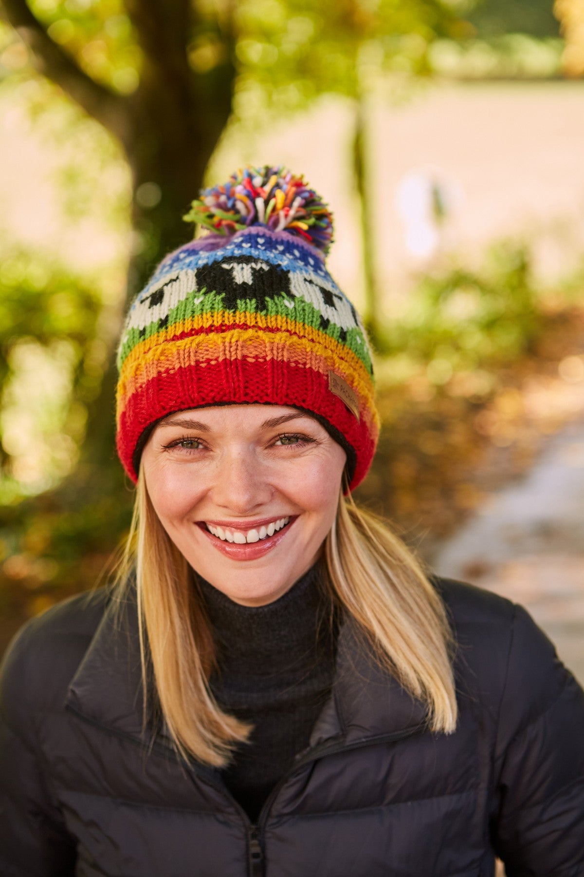 Pachamama Black Sheep Roll Back Bobble Beanie, Hand Knitted, Lined, Wool, Rainbow