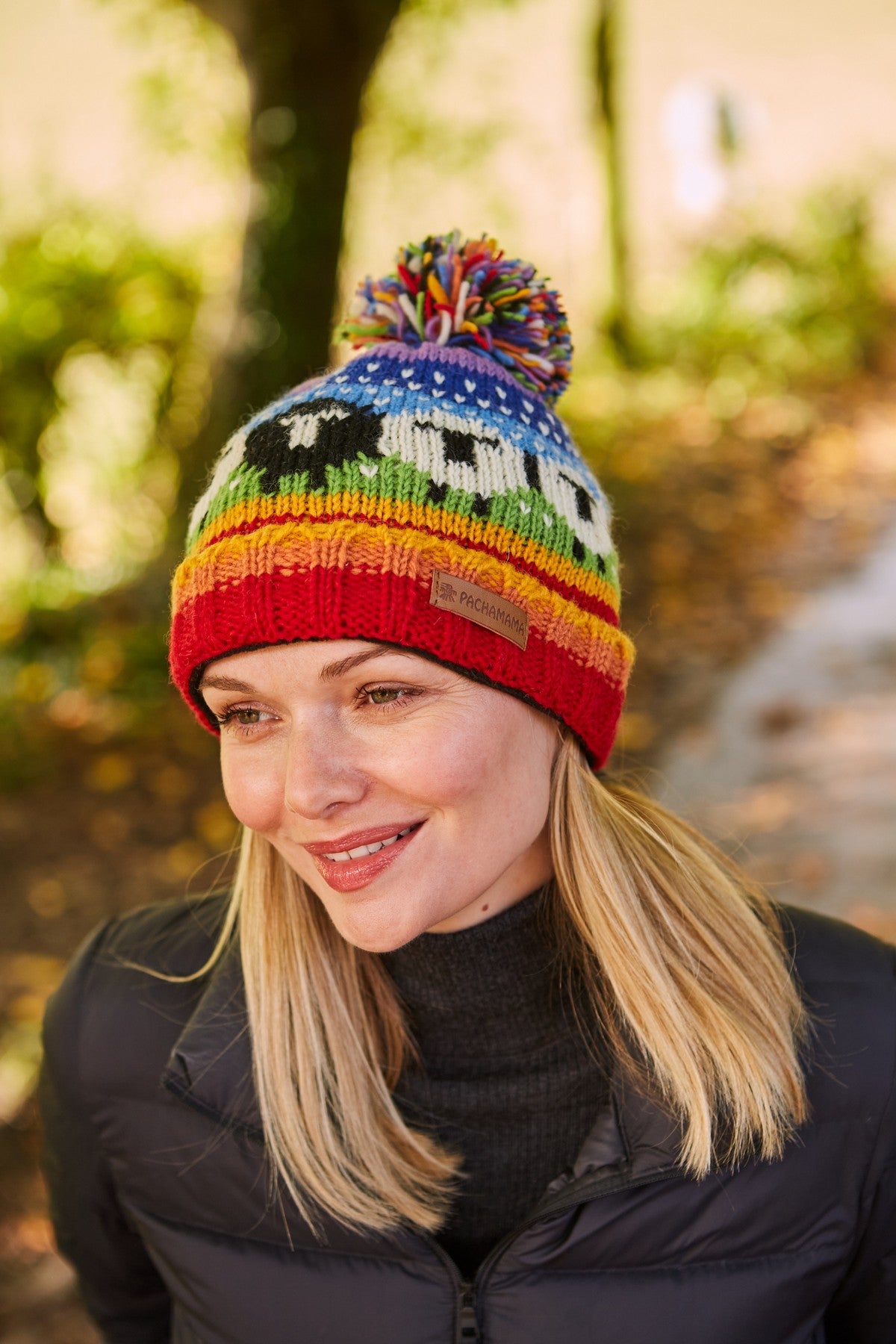 Pachamama Black Sheep Roll Back Bobble Beanie, Hand Knitted, Lined, Wool, Rainbow